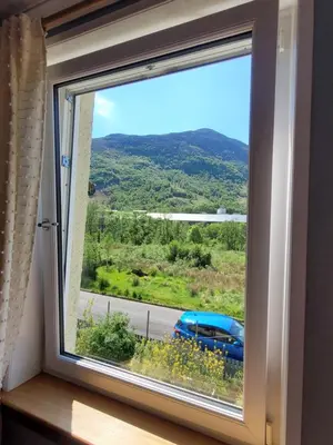 a window with a view of a blue car at Forest View Guesthouse, Kinlochleven WHW in Kinlochmore