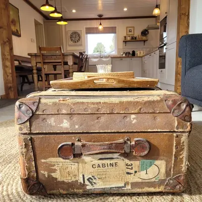 an old suitcase sitting on the floor in a kitchen at Blair Cottage in Rowardennan
