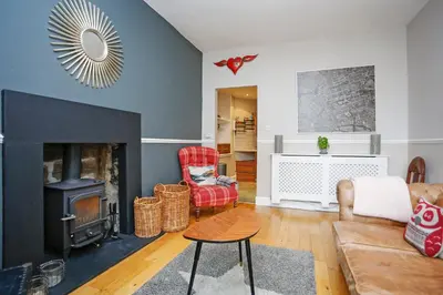 a living room with a couch and a fireplace at Walkable 1BR Near Castle, Grassmarket, Food in Edinburgh