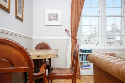 a living room with a table and a couch at Walkable 1BR Near Castle, Grassmarket, Food in Edinburgh