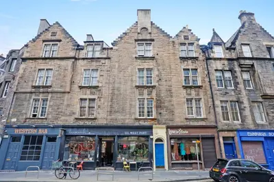 a large brick building on the corner of a street at Walkable 1BR Near Castle, Grassmarket, Food in Edinburgh