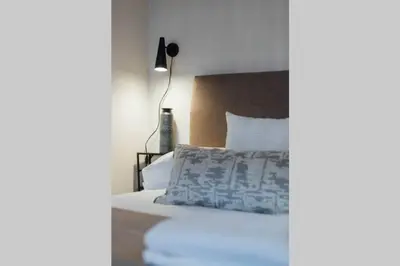 a bedroom with a bed and a lamp at Glasgow Central Luxury Apartment in Glasgow