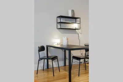 a dining room table with chairs and a shelf at Glasgow Central Luxury Apartment in Glasgow