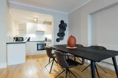 a kitchen and dining room with a table and chairs at Glasgow Central Luxury Apartment in Glasgow
