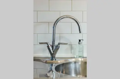 a kitchen sink with a chrome kitchen faucet at Glasgow Central Luxury Apartment in Glasgow