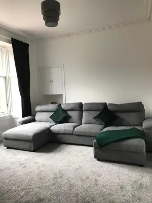 a living room with a gray couch in a room at Carvetii - Edward House A - 2 Dbl bed 1st floor flat in Dunfermline