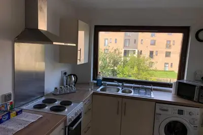 a kitchen with a sink and a window at Chic 2 Bed Apartment with Free Parking- Recently Redecorated, 10 Minutes to City Centre in Edinburgh
