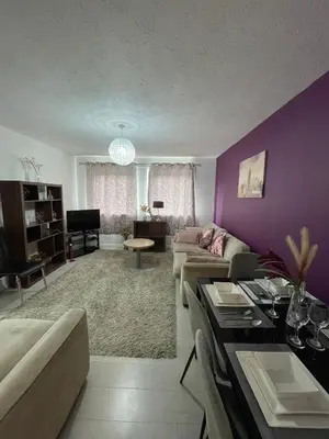 a living room with purple walls and a couch at Chic 2 Bed Apartment with Free Parking- Recently Redecorated, 10 Minutes to City Centre in Edinburgh