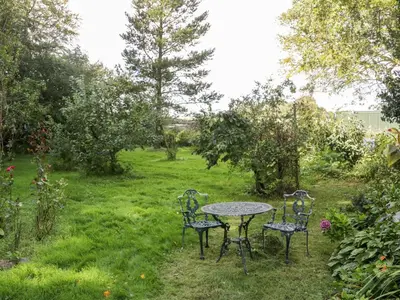 a table and chairs in a garden at The Coach House in Newton Stewart