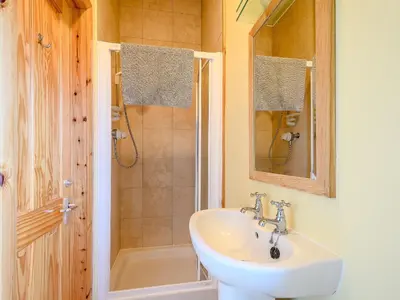 a bathroom with a sink and a shower at Ard Cuan in Torbeg