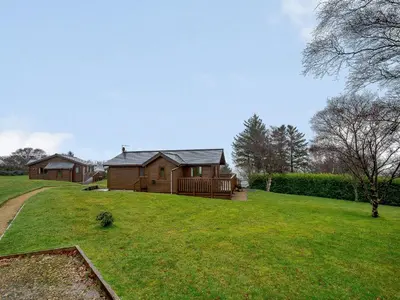 a house on a grassy yard with a house at Ard Cuan in Torbeg