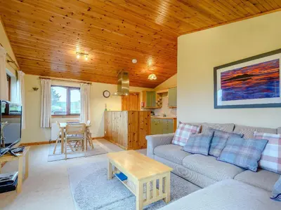 a living room with a couch and a table at Ard Cuan in Torbeg