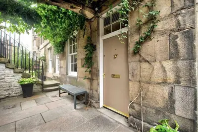 a door with a bench in front of a building at Hamilton Place - Beautiful and central city apartment with private entrance sleeps 4 in Edinburgh