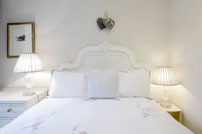 a bedroom with a white bed with two lamps at Hamilton Place - Beautiful and central city apartment with private entrance sleeps 4 in Edinburgh