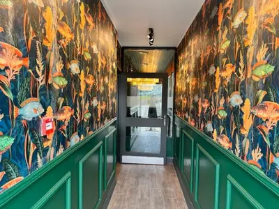 a hallway with a door and a mural of flowers at Lomond Park Hotel in Balloch