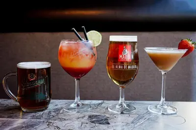 three glasses of different types of drinks on a table at Lomond Park Hotel in Balloch