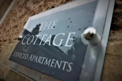 a sign that says the concrete awarded apartments at Signature - Linden Cottage Room 3 in Airdrie