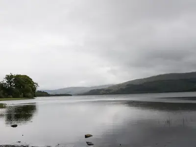 a large body of water with mountains in the background at Millmore Cabin in Killin