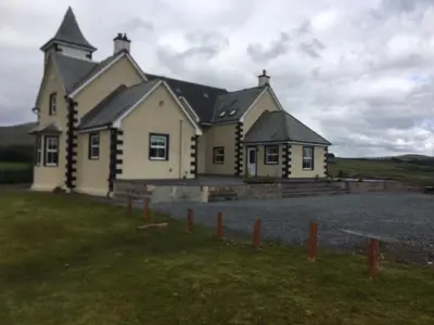 a large house in the middle of a field at Cumnock Knowes Holiday Retreat in Carsphairn