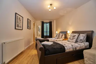 a bedroom with a bed and a couch at Edinburgh Pearl Apartments - Fountainbridge Residence in Edinburgh