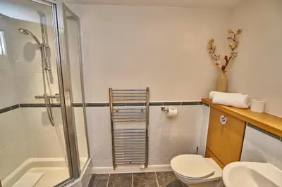 a bathroom with a shower and a toilet and a sink at Edinburgh Pearl Apartments - Fountainbridge Residence in Edinburgh