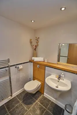 a bathroom with a toilet and a sink at Edinburgh Pearl Apartments - Fountainbridge Residence in Edinburgh