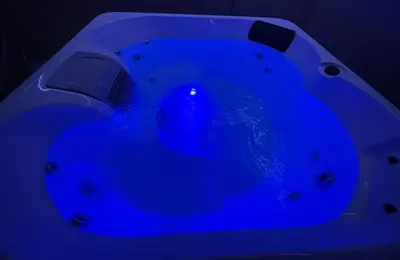 a blue bathtub in a dark room at Golden Crown exclusive use spa venue in Tarbolton