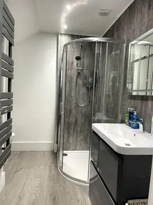 a bathroom with a shower and a sink at Premier Studio B in Broxburn