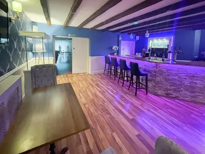 a bar with chairs and a table in a room at Dalgarven Spa House in Dalry