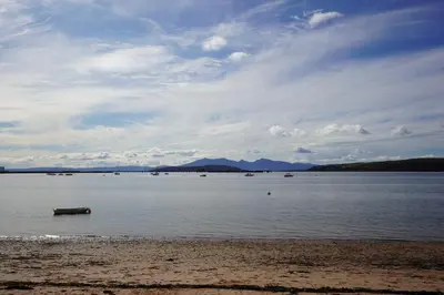 a large body of water with boats in it at Beach house no2 with amazing sea views and private garden onto beach. in Fairlie