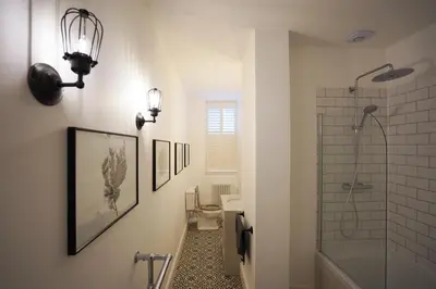 a bathroom with a shower and a toilet and a sink at Beach house no2 with amazing sea views and private garden onto beach. in Fairlie