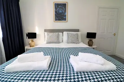 a bedroom with a bed with two pillows on it at Jess View in Renfrew