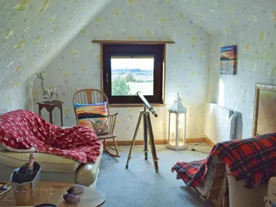 a living room with a couch and a window at Glen Rosa in Ayr