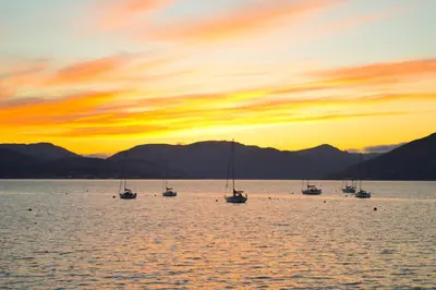a group of boats in the water at sunset at Keek Oot at 73 in Gourock