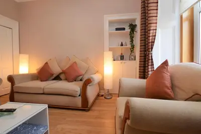 a living room with two chairs and a couch at Keek Oot at 73 in Gourock