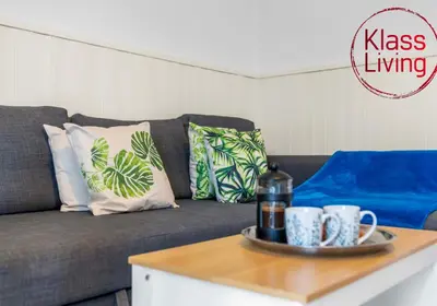 a living room with a couch and a coffee table at Nicol Apartment by Klass Living Airdrie in Airdrie