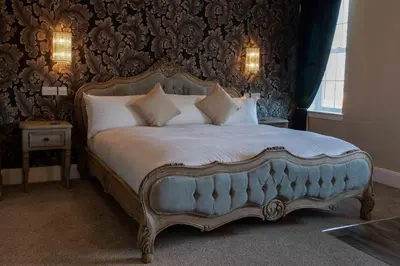a bedroom with a large bed in a room at The Inn At Charlestown in Dunfermline