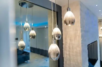 a room with several lights hanging from a wall at The Shore in Queensferry