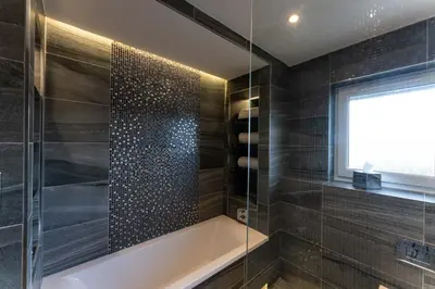 a bathroom with a bath tub and a window at The Shore in Queensferry