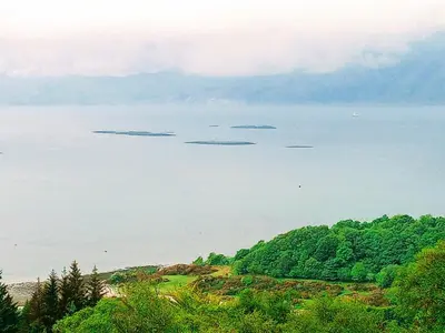 a view of a large body of water with trees at Granite Croft in Appin