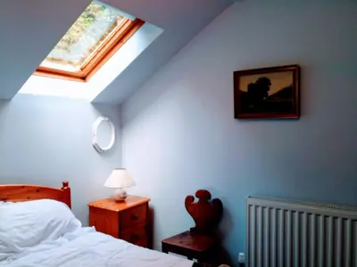 a bedroom with a bed and a skylight at Granite Croft in Appin
