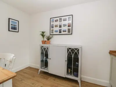 a room with a white cabinet with glass doors at Ellanderroch in Glasgow