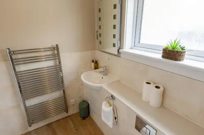 a bathroom with a sink and a window at Bachilton Farm Holidays in Perth