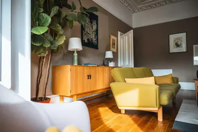 a living room with a couch and a chair at 16 1 Eildon Street in Edinburgh