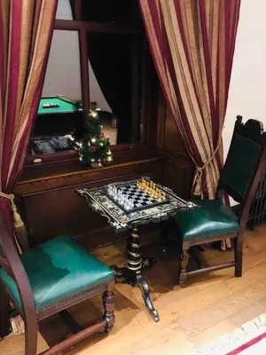 a room with a chess table and two chairs at Beautiful 4-Bed Villa in Glasgow in Glasgow