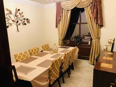 a dining room with a table and chairs and a window at Beautiful 4-Bed Villa in Glasgow in Glasgow