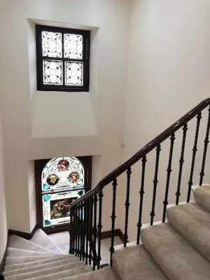 a staircase with a stained glass window in a house at Beautiful 4-Bed Villa in Glasgow in Glasgow