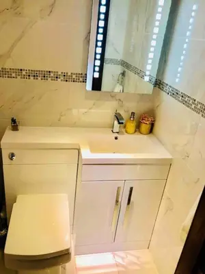a bathroom with a sink and a toilet and a mirror at Beautiful 4-Bed Villa in Glasgow in Glasgow