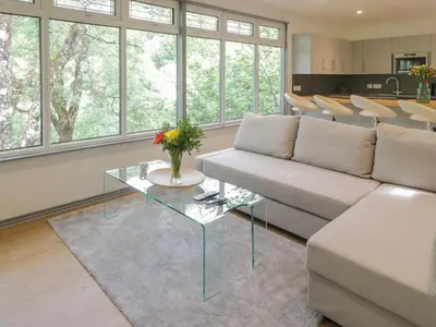 a living room with a couch and a table at The River Lodge in Oban