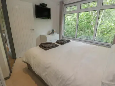 a bedroom with a bed with two towels on it at The River Lodge in Oban